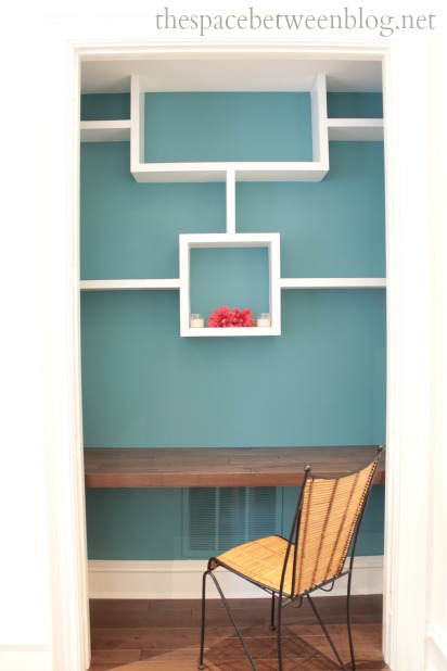 white shelving and wooden desk built into closet