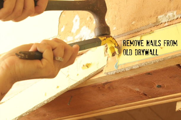 use a pry bar to remove nails from old drywall