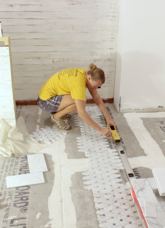 tiling a floor with mosaic tile